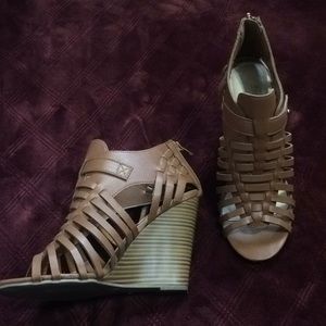 Taupe gladiator sandals with a wedged heel